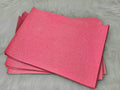 Stack of #28 pink glow-in-the-dark glitter faux leather sheets with a fine shimmer