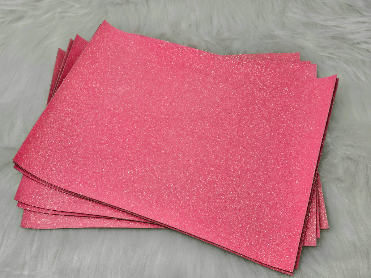 Stack of #28 pink glow-in-the-dark glitter faux leather sheets with a fine shimmer