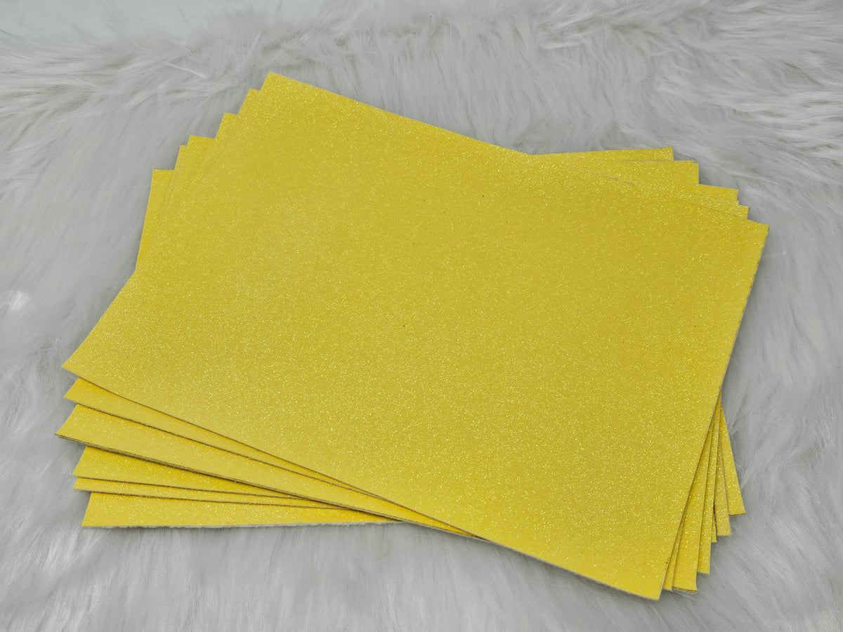 Stack of #29 yellow glow-in-the-dark glitter faux leather sheets with a fine shimmer