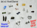 Set #2 of mixed charms on white fur, including feathers, trains, steer skulls, chandelier pieces and a spiked heart