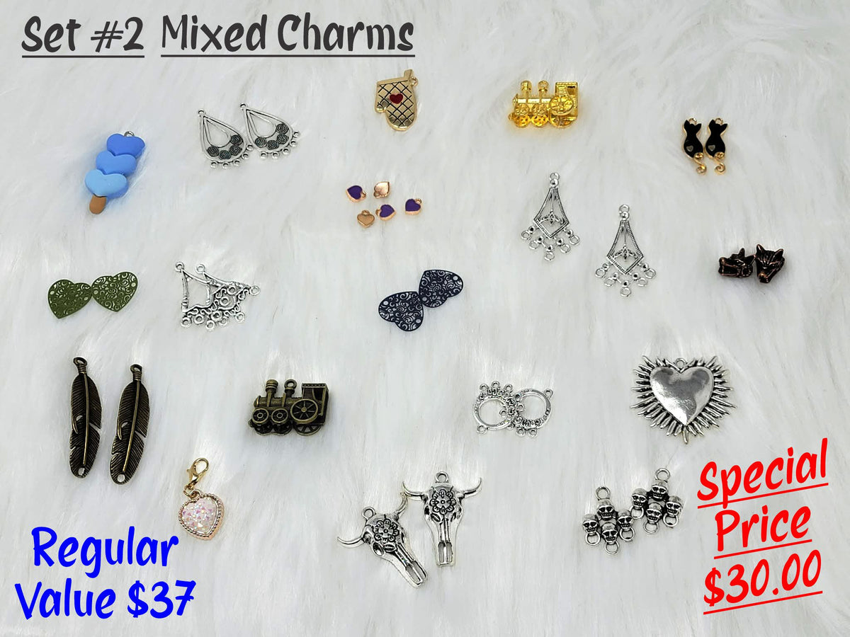 Set #2 of mixed charms on white fur, including feathers, trains, steer skulls, chandelier pieces and a spiked heart