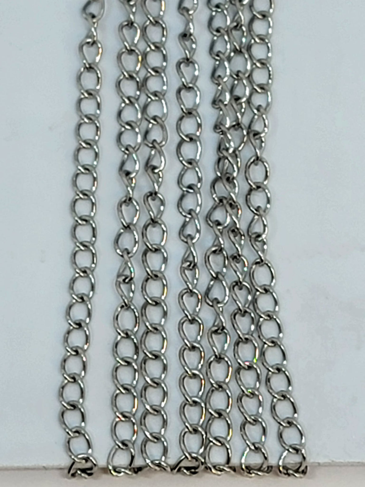Hanging strands of 2 x 3mm rhodium stainless steel link chain