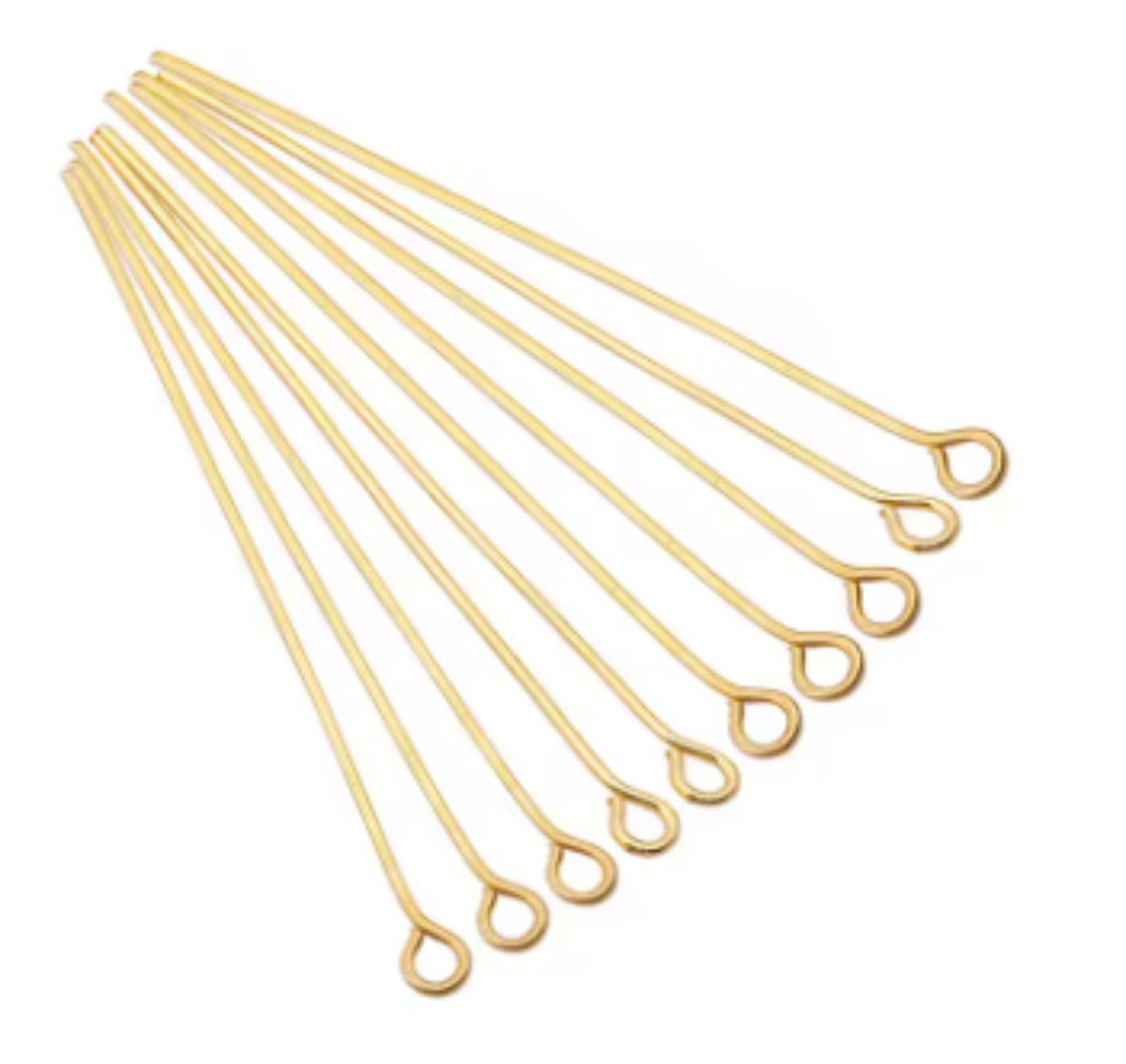 Fan of 30mm gold 20 gauge eye pins, each with a small round loop at one end, on white