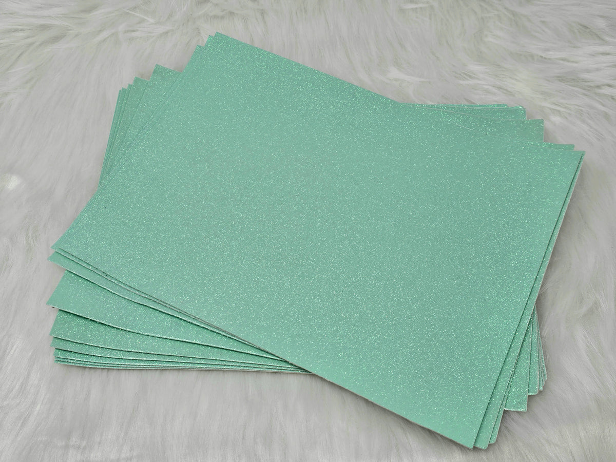 Stack of #31 blue glow-in-the-dark glitter faux leather sheets with a fine shimmer