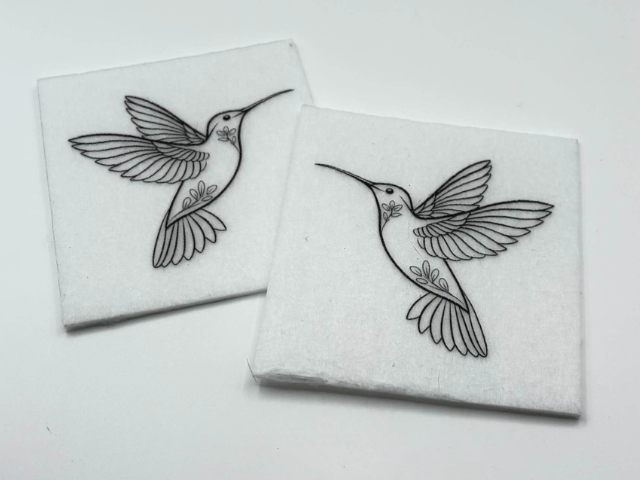 Two beading patterns printed in black on stiff white pellon squares, showing a hummingbird with a patterned body