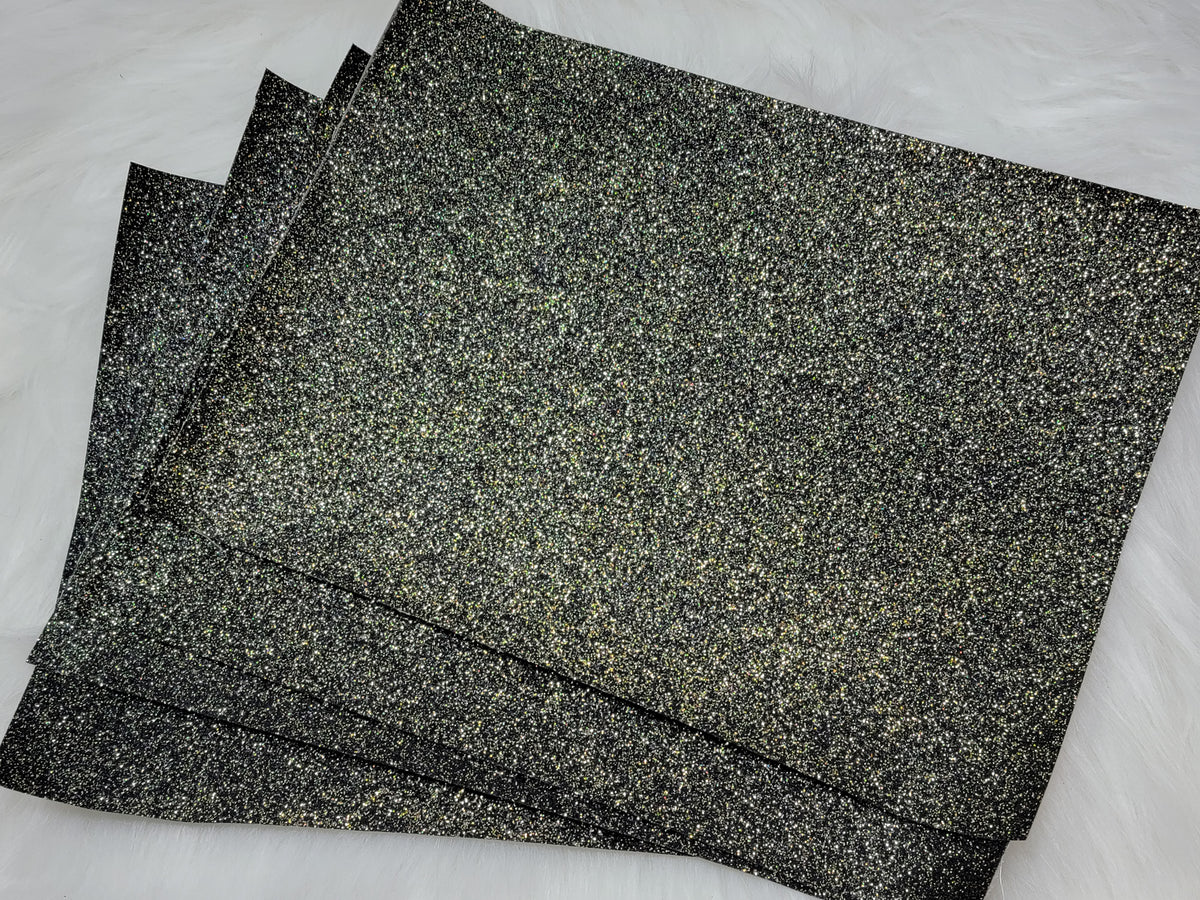 Stack of #33 black gold glitter faux leather sheets with a sparkly textured surface