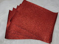Stack of #36 red glitter faux leather sheets with a sparkly textured surface