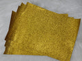Stack of #37 yellow glitter faux leather sheets with a sparkly textured surface