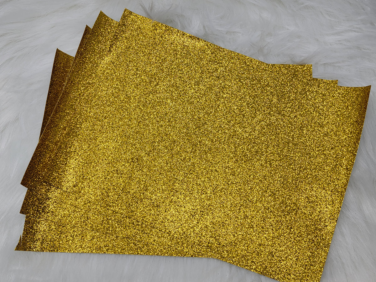 Stack of #37 yellow glitter faux leather sheets with a sparkly textured surface