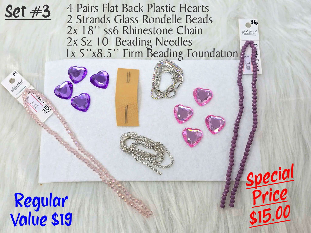 Set #3: faceted purple and pink plastic hearts, two rondelle strands, rhinestone chain and needles on white foundation