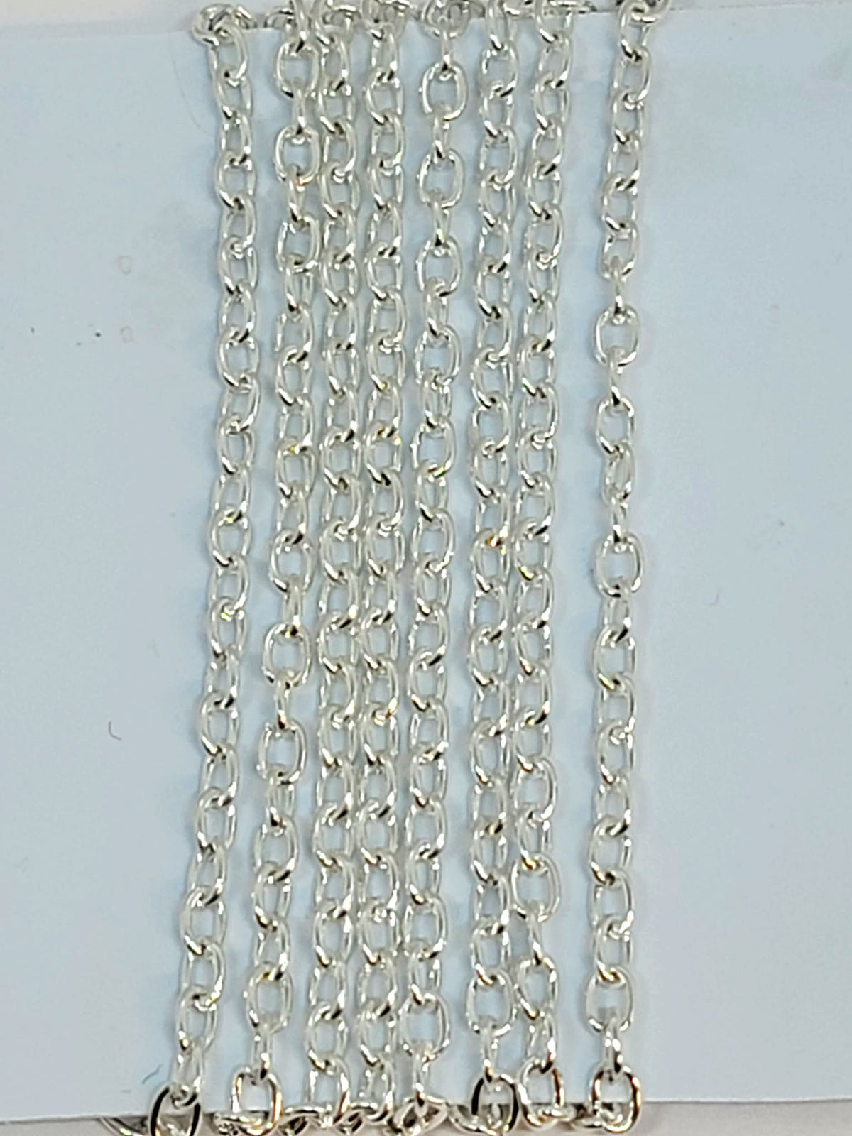 Hanging strands of 3 x 4mm silver stainless steel link chain