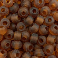 Close-up of 9mm glass crow beads in matte transparent amber, filling the frame