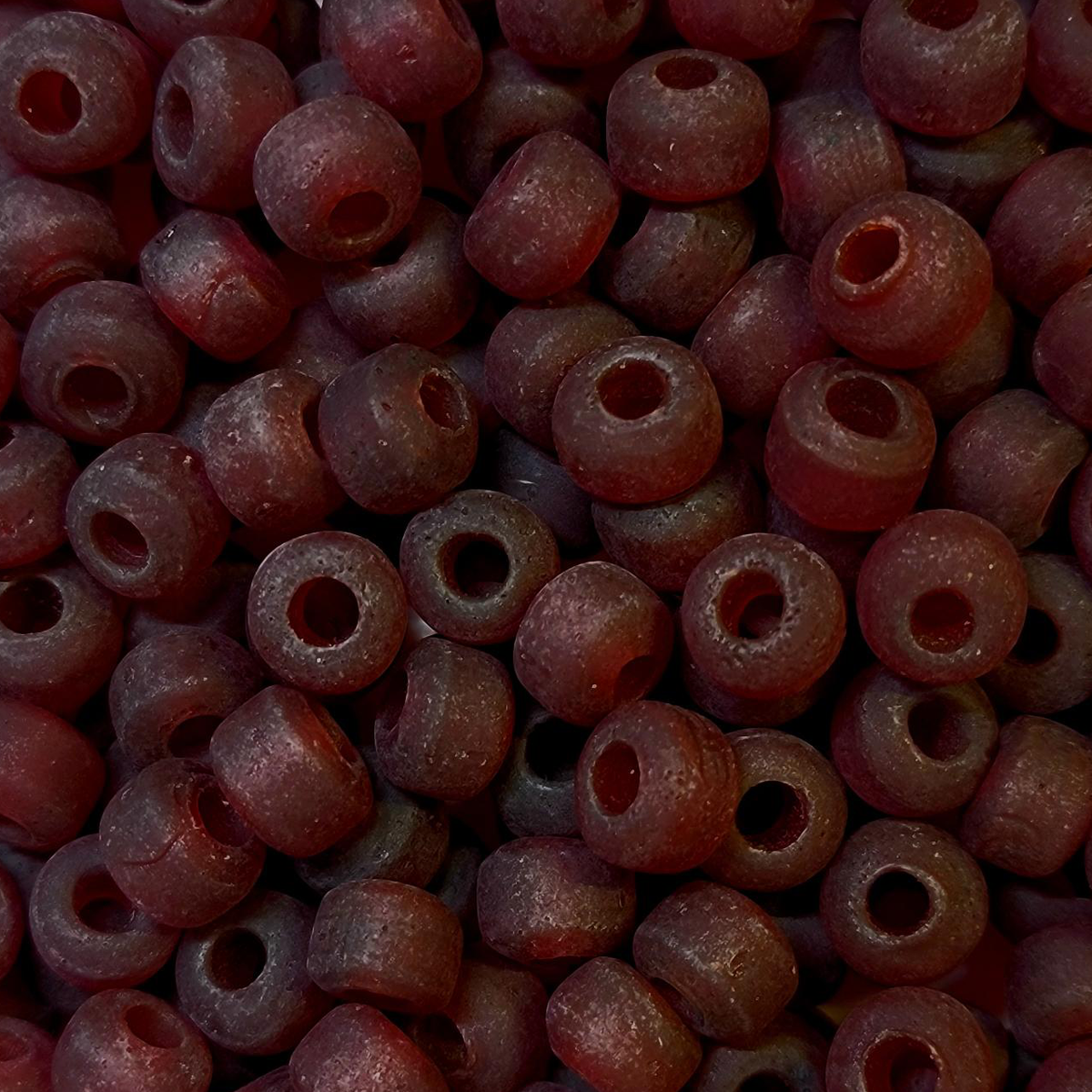 Close-up of 9mm glass crow beads in matte transparent dark red