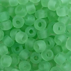Close-up of 9mm glass crow beads in matte transparent honeydew green
