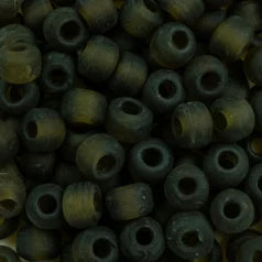 Close-up of 9mm glass crow beads in matte transparent kiwi, filling the frame