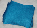 Stack of #40 light blue glitter faux leather sheets with a sparkly textured surface