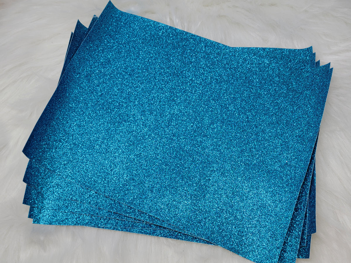 Stack of #40 light blue glitter faux leather sheets with a sparkly textured surface