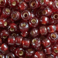 Close-up of 9mm glass crow beads in red with a lustre finish