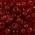 Close-up of 9mm glass crow beads in transparent red, filling the frame