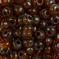 Close-up of 9mm glass crow beads in transparent topaz, filling the frame