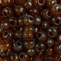 Close-up of 9mm glass crow beads in transparent topaz, filling the frame