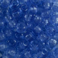 Close-up of 9mm glass crow beads in transparent sky blue, filling the frame