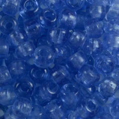 Close-up of 9mm glass crow beads in transparent sky blue, filling the frame