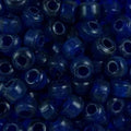 Close-up of 9mm glass crow beads in transparent royal blue, filling the frame