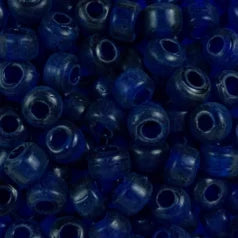Close-up of 9mm glass crow beads in transparent royal blue, filling the frame
