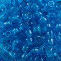 Close-up of 9mm glass crow beads in transparent aqua, filling the frame