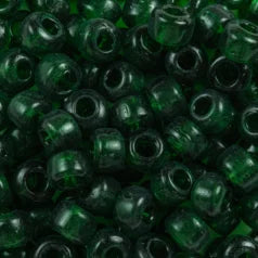 Close-up of 9mm glass crow beads in transparent forest green