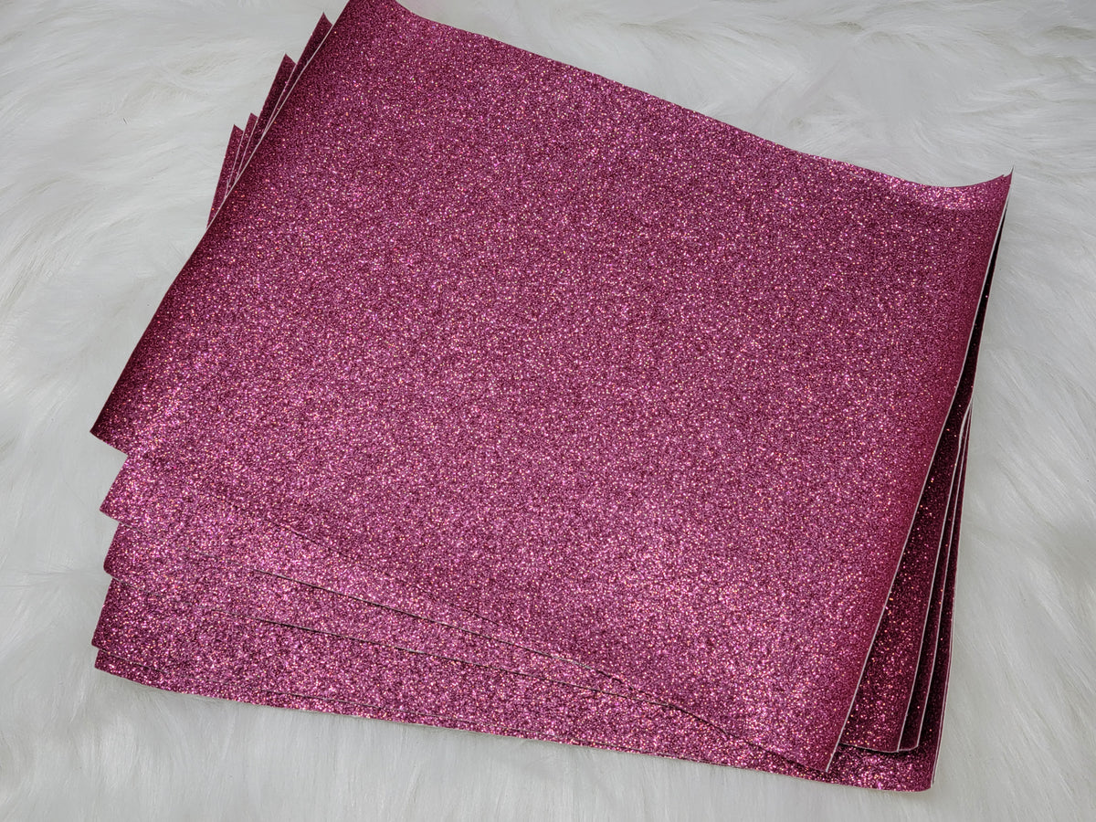 Stack of #43 pink glitter faux leather sheets with a sparkly textured surface