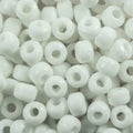 Close-up of 9mm glass crow beads in opaque white, filling the frame