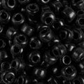 Close-up of 9mm glass crow beads in opaque black, filling the frame