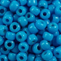 Close-up of 9mm glass crow beads in opaque turquoise, filling the frame