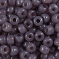 Close-up of 9mm glass crow beads in opaque dark taupe, filling the frame