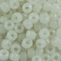 Close-up of 9mm glass crow beads in opaque pearly white, filling the frame