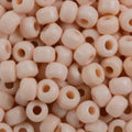 Close-up of 9mm glass crow beads in opaque cream, filling the frame