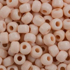 Close-up of 9mm glass crow beads in opaque cream, filling the frame