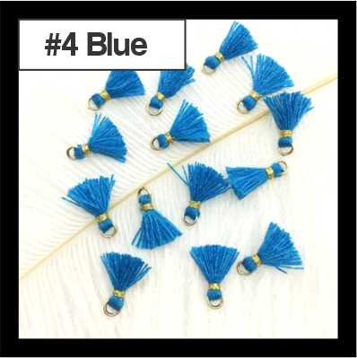 Scattered 1cm blue cotton tassels with gold-tone rings on white fur, labelled #4