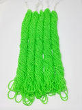 Five hanks of Preciosa 11/0 transparent neon green seed beads laid out on a white background