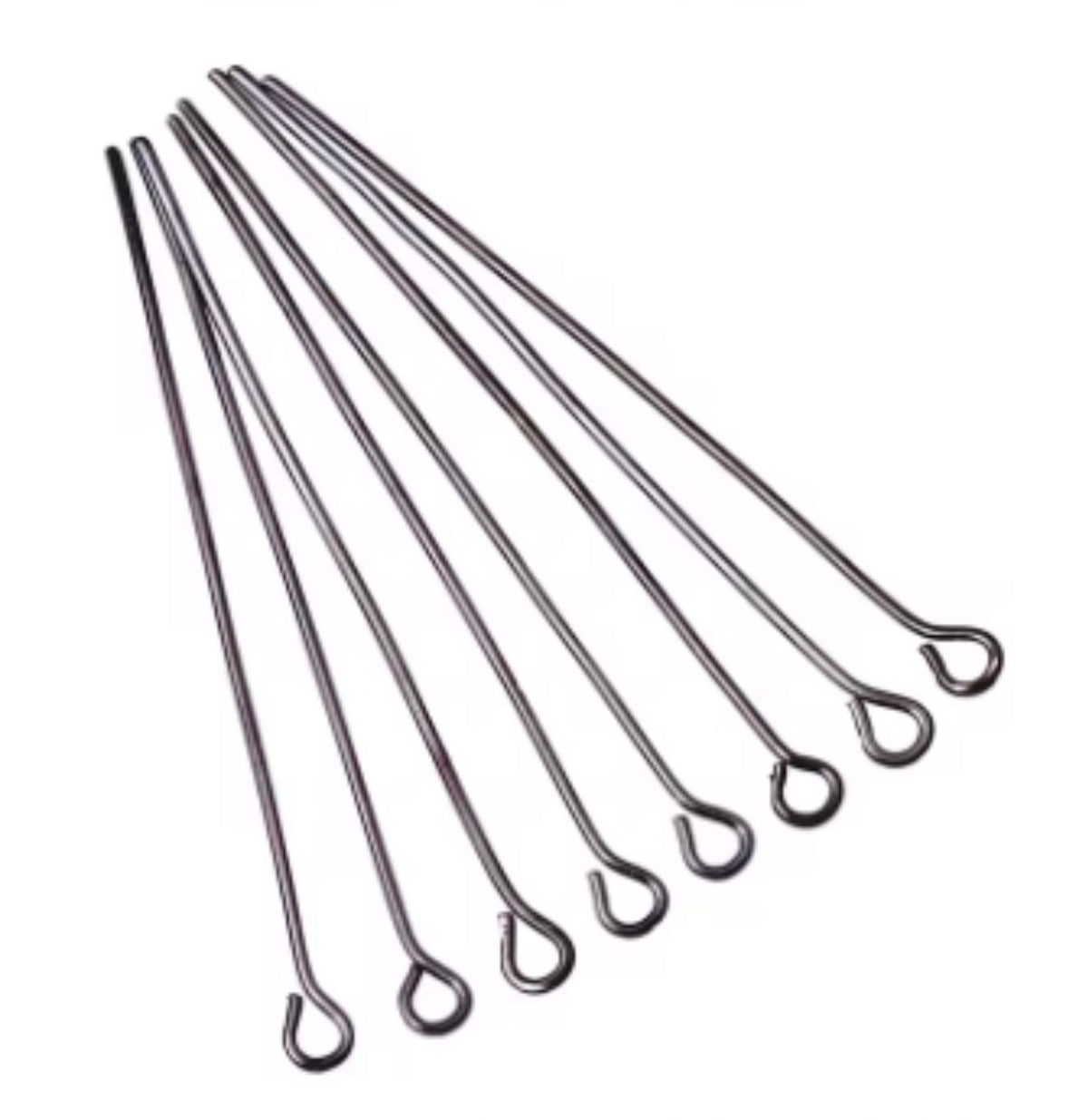 Fan of 50mm gunmetal 20 gauge eye pins, each with a small round loop at one end, on white