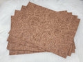 Stack of #53 tan faux leather sheets embossed with a tooled floral scroll pattern