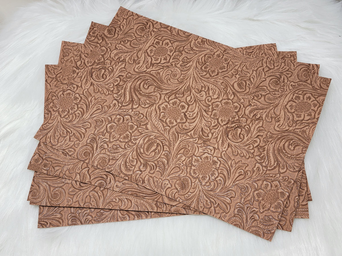 Stack of #53 tan faux leather sheets embossed with a tooled floral scroll pattern