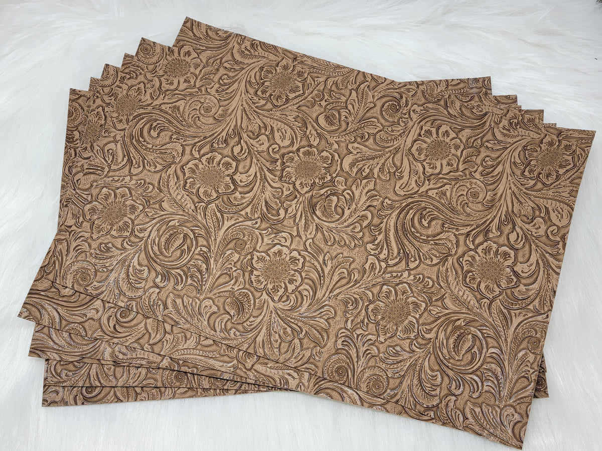 Stack of #54 sand faux leather sheets embossed with a tooled floral scroll pattern