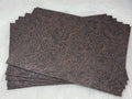 Stack of #56 coffee faux leather sheets embossed with a tooled floral scroll pattern