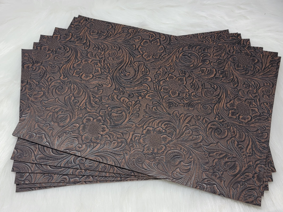Stack of #56 coffee faux leather sheets embossed with a tooled floral scroll pattern