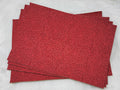 Stack of #59 red faux leather sheets embossed with a tooled floral scroll pattern