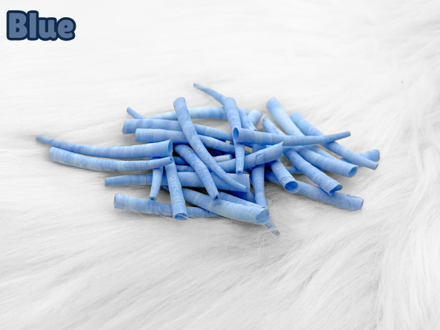 Pile of blue dyed smooth dentalium shells, about 1.5 to 2 inches long, on white faux fur