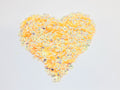 Heart-shaped pile of 6mm iridescent flower sequins in creamsicle